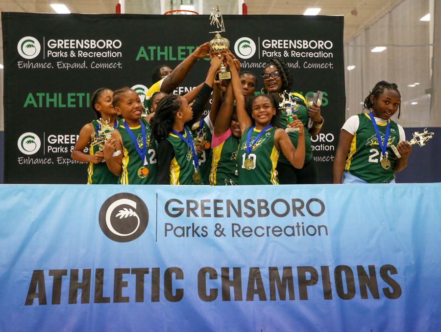 young girls basketball team with a trophy