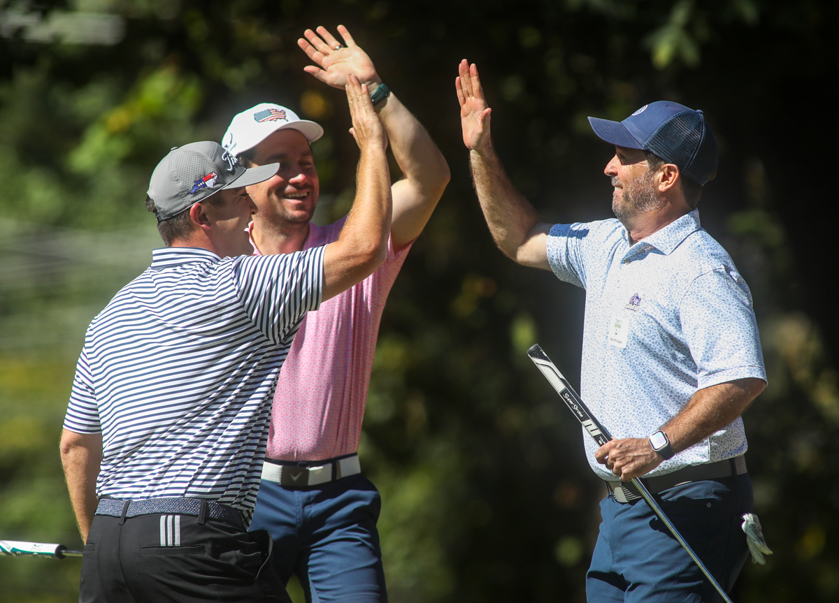 3 men giving a high five